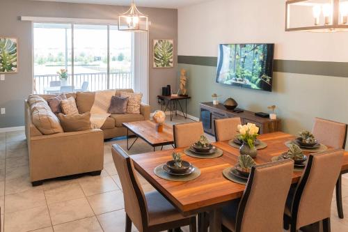 a living room with a table and a couch at Disney Magic ChampionsGate Resort House 15 min from Disney World, with Club House, 7 Pools and Water Park in Kissimmee