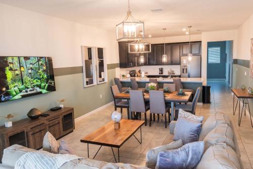 a living room with a couch and a dining room at Disney Magic ChampionsGate Resort House 15 min from Disney World, with Club House, 7 Pools and Water Park in Kissimmee