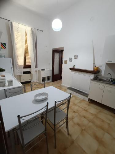 a kitchen with a table and chairs in a room at A casa di Irene in Le Marmore