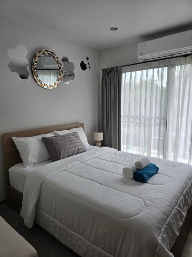 a bedroom with a bed with a teddy bear on it at La Habana Huahin by J2A in Hua Hin