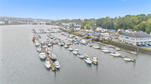 a group of boats docked at a dock in the water at Near YALE - Beautiful Waterfront Townhouse in New Haven in New Haven