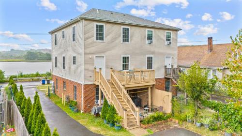a large house with a staircase leading up to it at Near YALE - Beautiful Waterfront Townhouse in New Haven in New Haven