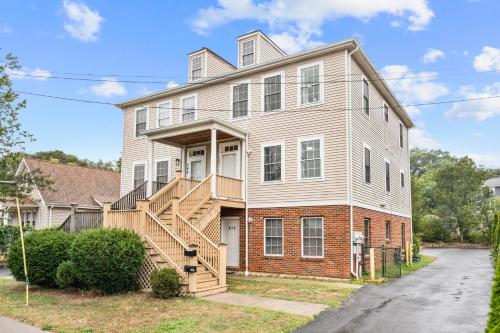 a large white house with a staircase in front of it at Near YALE - Beautiful Waterfront Townhouse in New Haven in New Haven