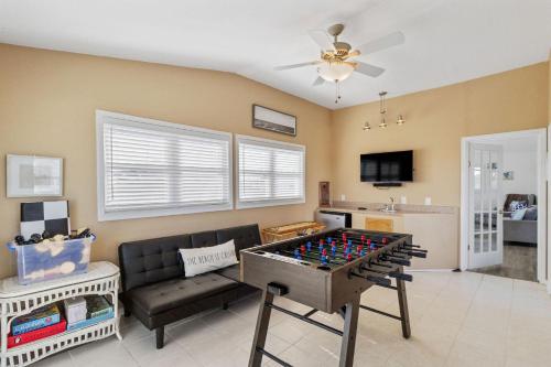 a living room with a ping pong table at It's A Vibe in Kitty Hawk