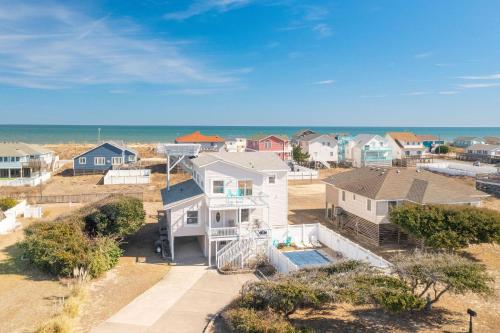 an aerial view of a neighborhood with houses and the ocean at It's A Vibe in Kitty Hawk