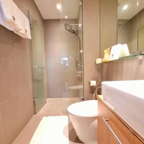 a bathroom with a shower and a toilet and a sink at BREATHTAKING BAYVIEWS - 1-5 BR Luxury and Superior Condos with Panoramic Bay Views, Balcony, Gym, Pool & Netflix - Housekeeping Available - in Manila