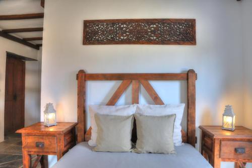 a bedroom with a wooden bed with two night stands at Monte Do Caneiro in Mourão