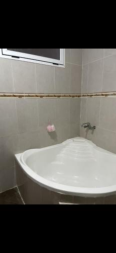 a white bath tub in a bathroom with a window at Aqoua private villa in Tetouan