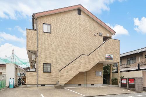 a building with a staircase on the side of it at C Frase Torikai in Muromimachi