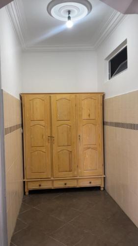 a row of wooden cabinets in an empty room at Aqoua private villa in Tetouan