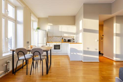 a kitchen with a table and chairs in a room at Oslo City Centre - Fortress & sea view in Oslo
