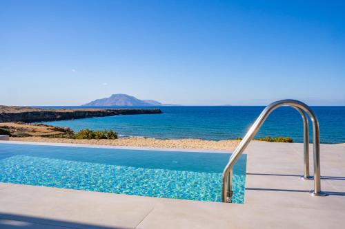 a swimming pool with a view of the ocean at Terramare Villas Karpathos in Foinikion
