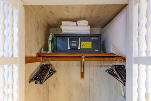 a small microwave sitting on a shelf in a room at MIA Airport Modern Studio 10 min Downtown Port in Miami