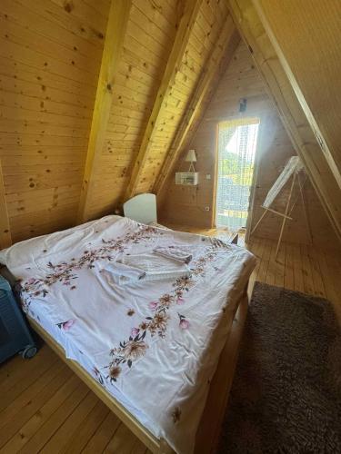 a bedroom with a bed in a wooden attic at Monte Casa in Ivišovo Greblje