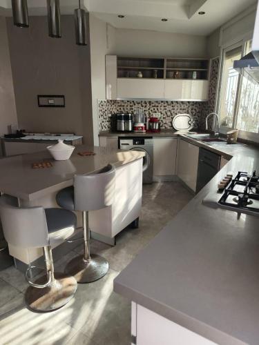 a kitchen with a large island in a kitchen at Tiba soliman plage in Nabeul