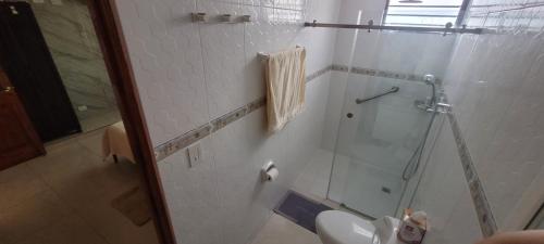 a bathroom with a glass shower and a sink at Panama City Full apartment 20th floor with a view of the sea and mountains in Panama City