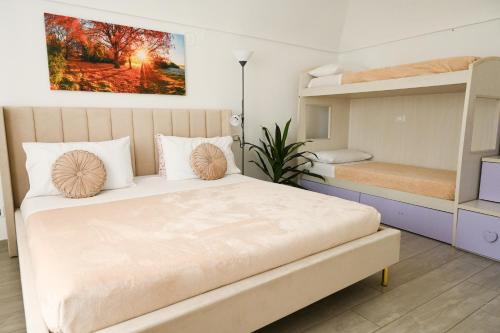 a bedroom with a bed and two bunk beds at CASA Vacanze EUREKA in Novi Ligure