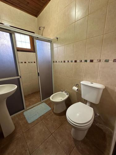 a bathroom with a toilet and a sink and a shower at La Rosa House - Central house in Eldorado in Eldorado