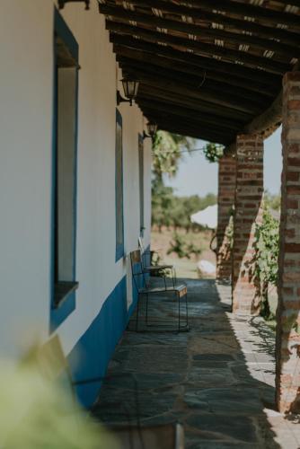 a chair sitting on a porch of a building at Monte Do Caneiro in Mourão