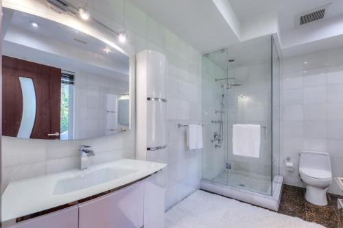 a bathroom with a sink and a shower and a toilet at Private Oasis in King City in King City