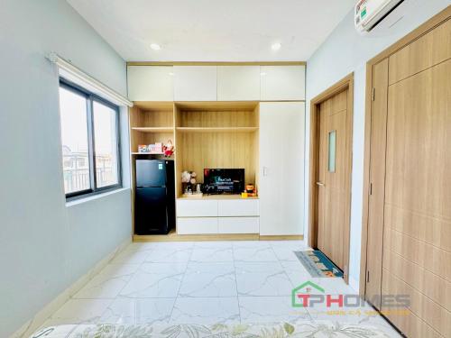 a kitchen with a black refrigerator and a window at TPHomes Lakeview 122 in Ho Chi Minh City