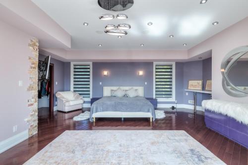 a bedroom with a king sized bed and purple walls at Private Oasis in King City in King City