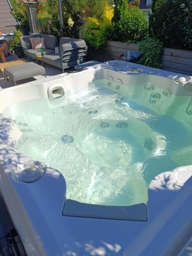 a jacuzzi hot tub in a backyard at Chambre avec jacuzzi extérieur in Strasbourg