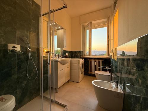 a bathroom with a shower and a sink and two toilets at Bella vista - Garda Lake in Bardolino