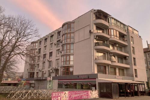 a large building with a rainbow in the sky at Apartment Saint George in Dobrich
