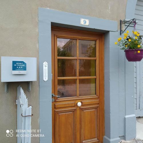 a wooden door on a building with a potted plant at Gite de la combe in Désandans