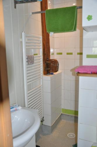 a white bathroom with a sink and a toilet at Gite de la combe in Désandans