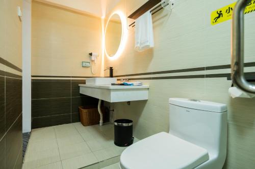 a bathroom with a toilet and a sink at The Lu Village Retreat in Guilin