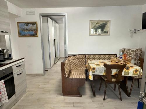 a kitchen with a dining room table and a table and chairs at Borgo Antico in Gamberale