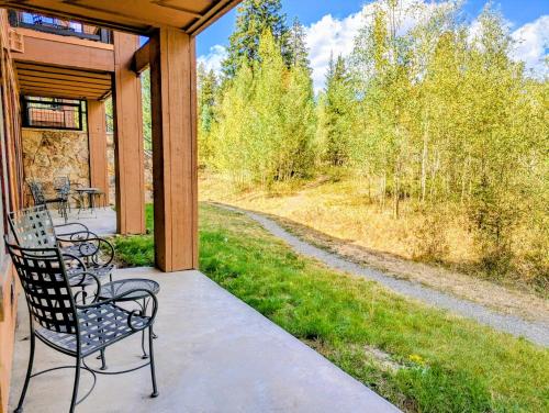 a porch with two chairs and a view of a field at Springs 8806 by SummitCove Lodging in Colorado in Keystone