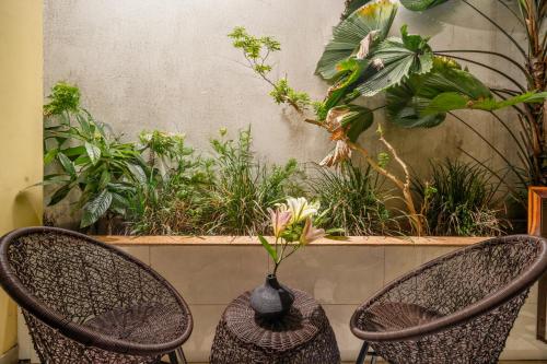 two wicker chairs with a vase sitting on top at Southern Hotel in Hoi An