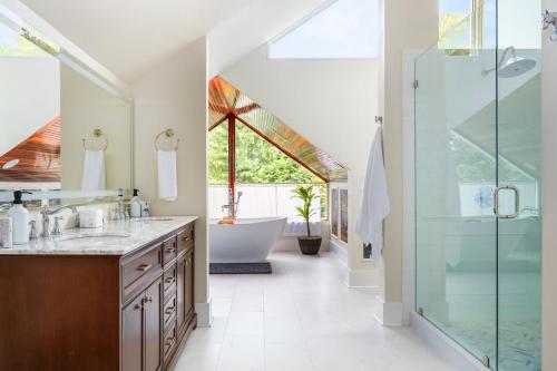 a bathroom with a tub and a sink and a shower at Bourbon Trail - Golf Sim, Speakeasy, Sauna, Hot Tub in Frankfort