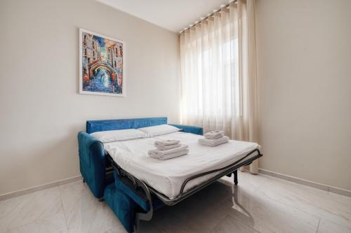 a bedroom with a blue bed with towels on it at Luxury Design Apartment Duomo in Milan