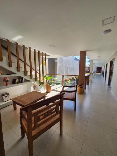 a living room with a wooden table and chairs at Terra Bella Pousada in Morro de São Paulo