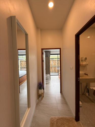 a hallway of a house with a mirror at Srithanu Escape 3 in Ban Madua Wan