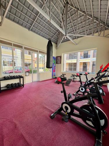 a gym with several treadmills and exercise bikes at Lipsy Homes Kungu in Kampala