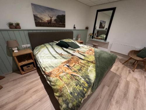 a bedroom with a bed with a blanket on it at B&B Stations Koffiehuis in Molkwerum