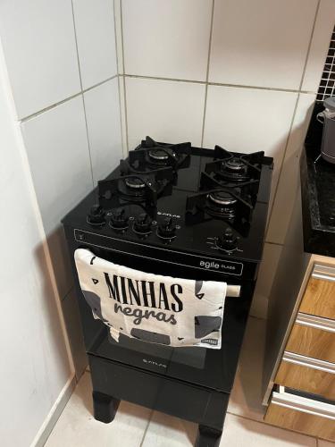a black stove in a kitchen with a sign on it at Brazilian Caribbean in Paraíba Wind Palace Flats in Cabedelo