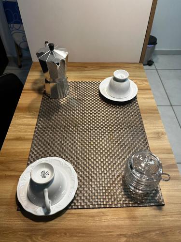 a table with two cups and plates on a table at Brazilian Caribbean in Paraíba Wind Palace Flats in Cabedelo