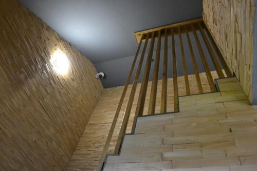 a staircase in a room with a wooden wall at Apartmány Špacír celý dům in Harrachov