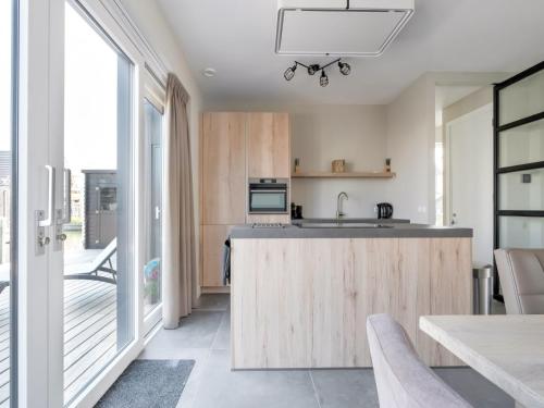 a kitchen with wooden cabinets and a counter top at Holiday Home in Stavoren with Jetty in Stavoren