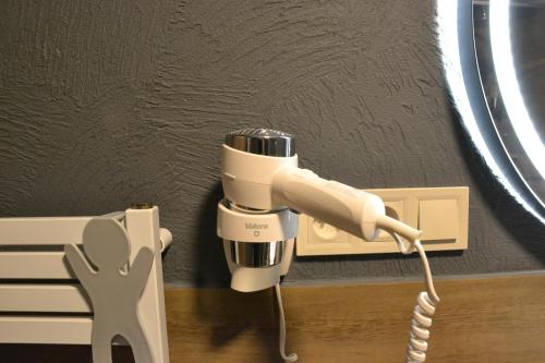 a phone is plugged into a wall at Apartmány Špacír celý dům in Harrachov