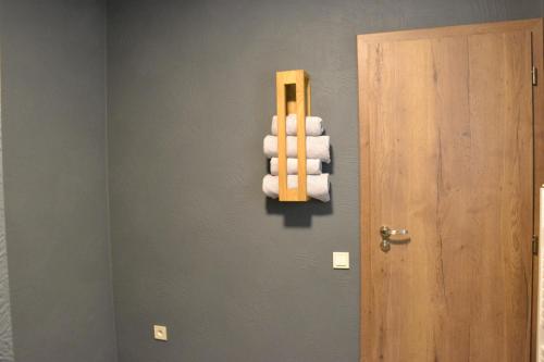 a stack of towels on a wall next to a door at Apartmány Špacír celý dům in Harrachov