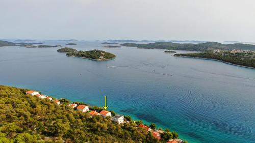 an island in a large body of water at Rozali Tisno Apartments in Tisno