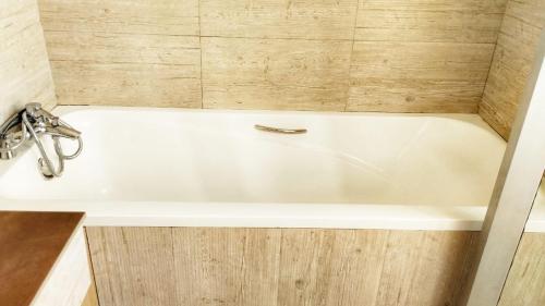 a white bath tub with a faucet in a bathroom at Lamuria Naserian Villa in Nanyuki