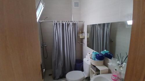 a bathroom with a shower and a toilet and a sink at Bright apartment in Tangier! in Tangier